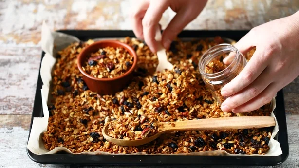 Frisklavet hjemmelavet granola på en bageplade. Granola i en træske og i en krukke. Selektiv fokus. Sund kost koncept. Keto diæt.